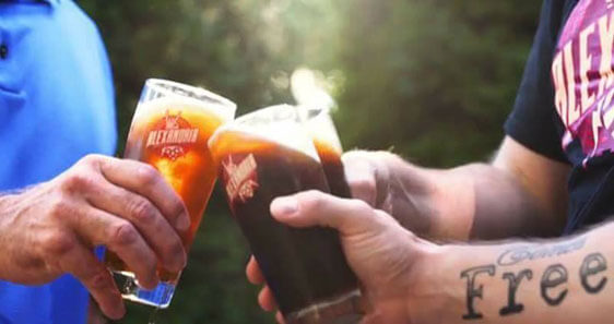 Alexandria Brewing Company Cheers three friends toast glasses with Alexandria Brewing Company logos on them