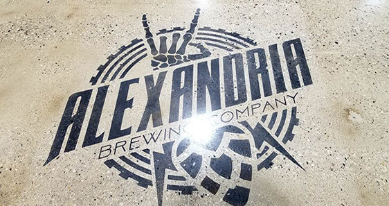 Alexandria Brewing Company Floor Logo Alexandria Brewing Company's logo embedded in treated concrete on the floor of their brewery